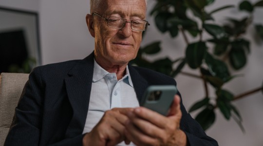 senior citizen exploring a website on his smartphone